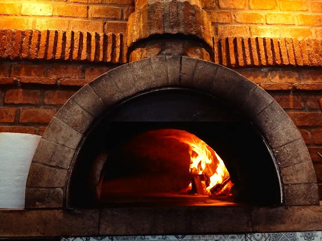 Wood fired pizza at Agli Amici Phuket, traditional Italian pizza oven in Chalong